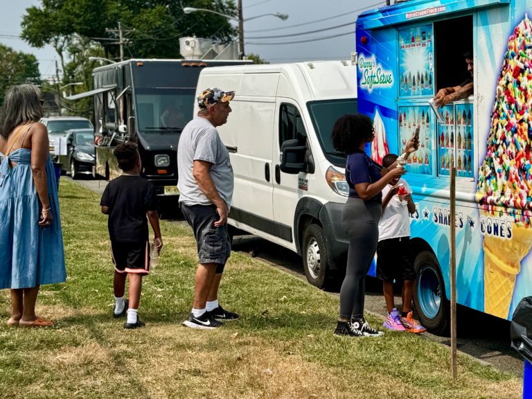 People lined up at an ice cream truck during the Mayor’s Cup basketball tournament at Madden Field.