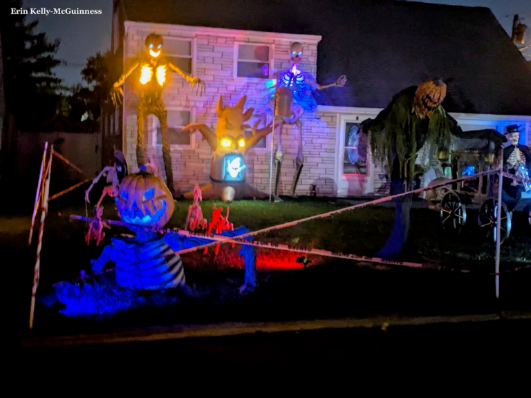 Giant skeleton and tombstones set up in front of a Rahway house with fog effects.
