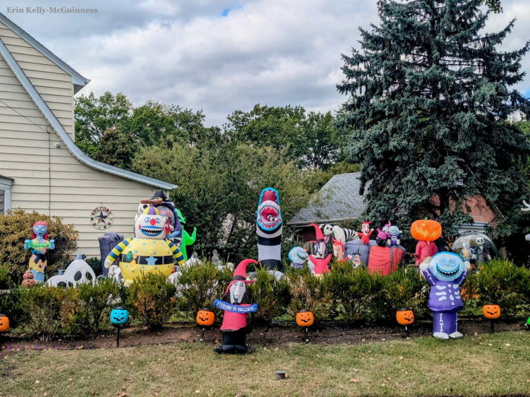 Child-friendly Halloween setup with inflatable ghosts and pumpkins on a Rahway front lawn.