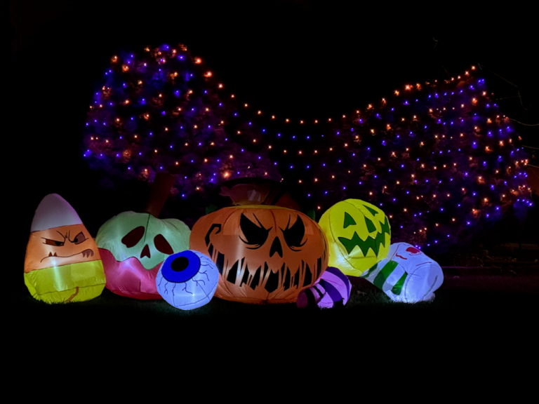 Close-up of Halloween skeleton in a Rahway yard surrounded by orange lights.