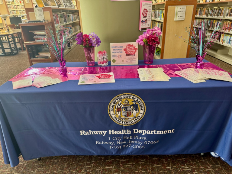 Rahway Health Department display table with breast cancer awareness materials inside the Rahway Public Library.