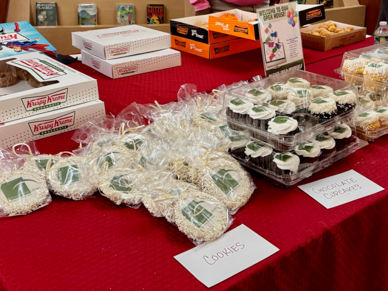 Table with cookies, cupcakes, and Krispy Kreme doughnuts displayed at the Rahway Public Library’s open house.