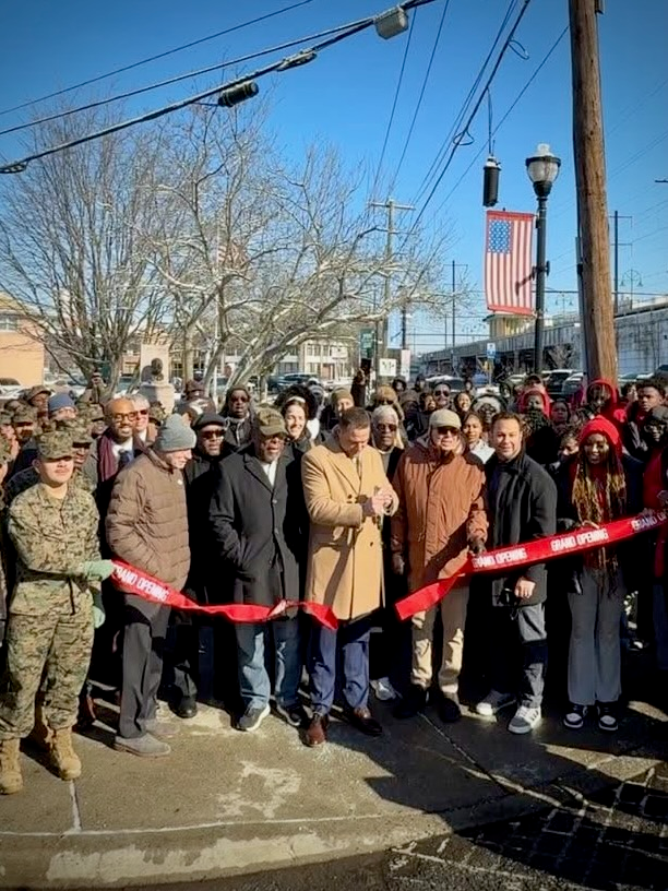 A local official speaks during a Martin Luther King Jr. Day ceremony at MLK Park in Rahway, with the Dr. King statue and attendees gathered on a winter morning.