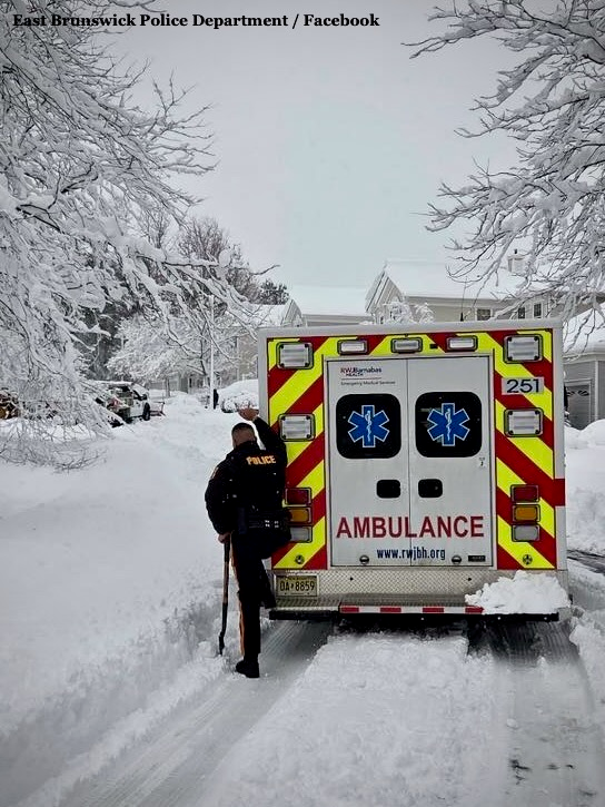 Blizzard Warning: Snow Routes, Towing, Trash Canceled Across Central Jersey 3 Ambulance and police officer on snow-covered street in East Brunswick NJ during February 2026 blizzard