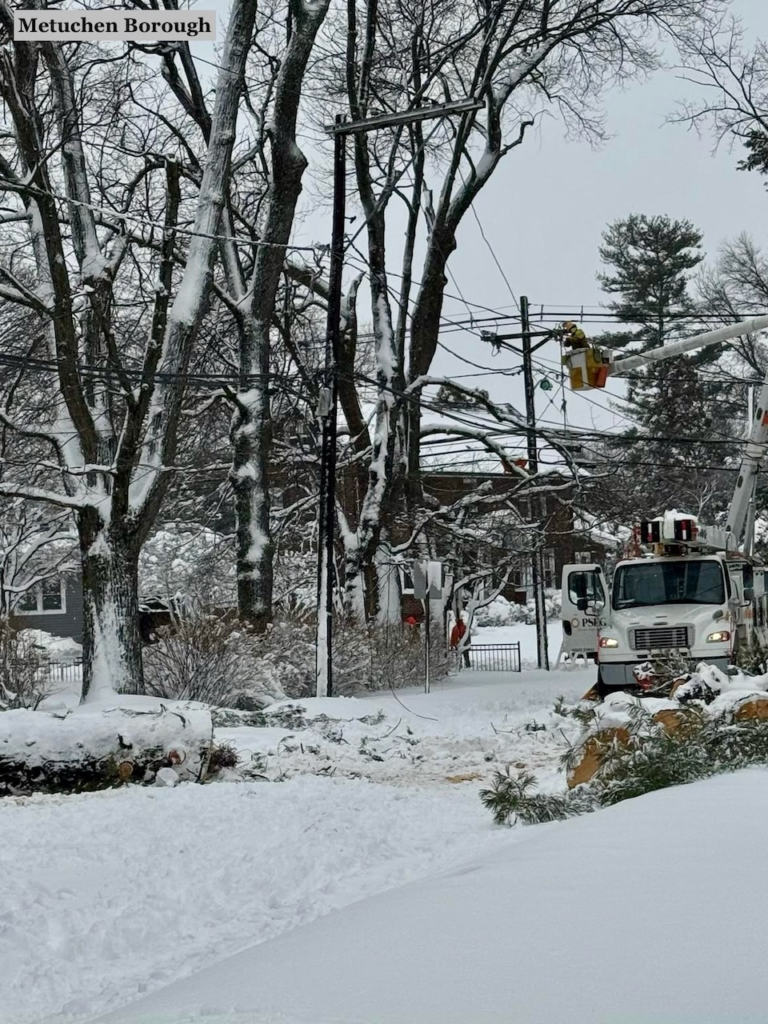 Blizzard Warning: Snow Routes, Towing, Trash Canceled Across Central Jersey 1 Utility crew repairs power lines after tree falls in snowstorm in Metuchen NJ February 2026